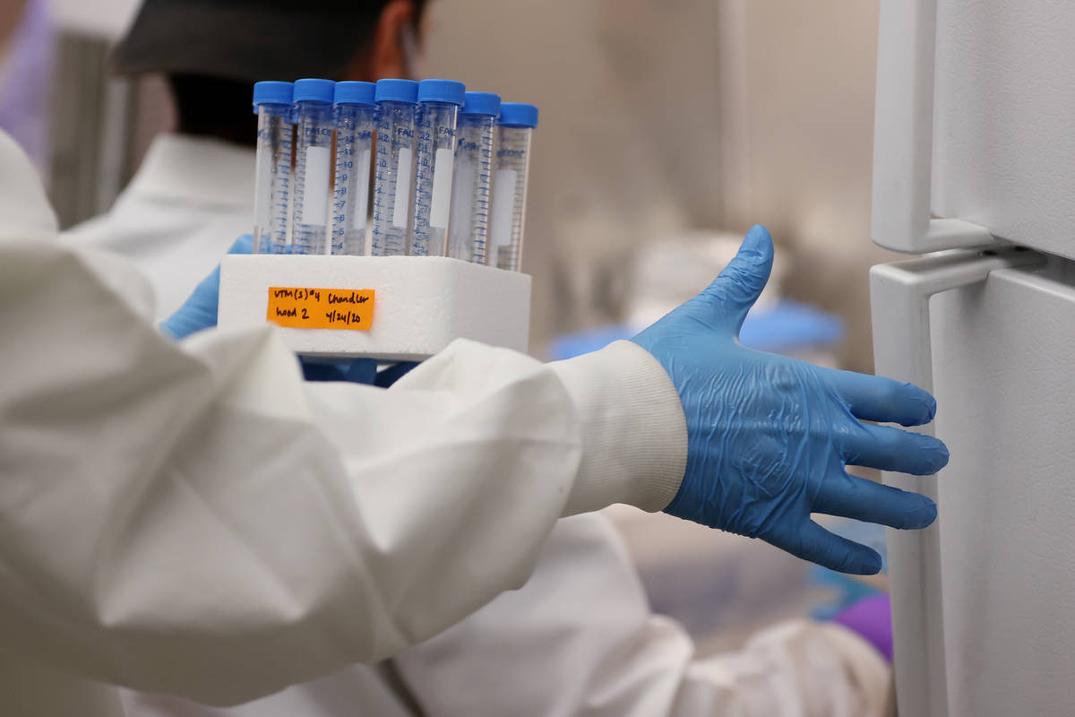 Lab manager Monika Karney stores completed vials filled with viral transport medium from gradua ...