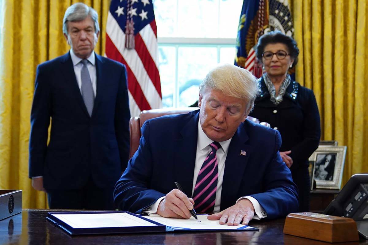 President Donald Trump signs a coronavirus aid package to direct funds to small businesses, hos ...