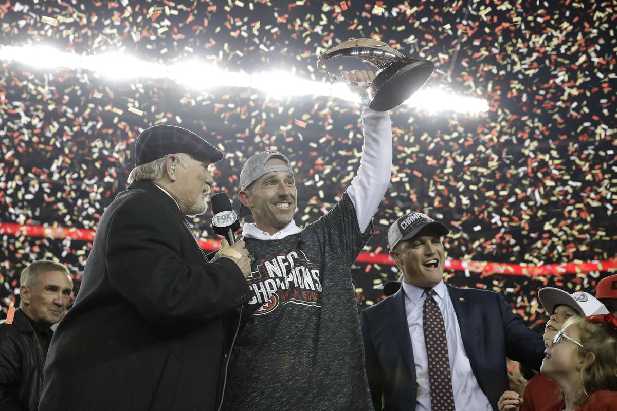 San Francisco 49ers head coach Kyle Shanahan, center, and general manager John Lynch, right, ce ...