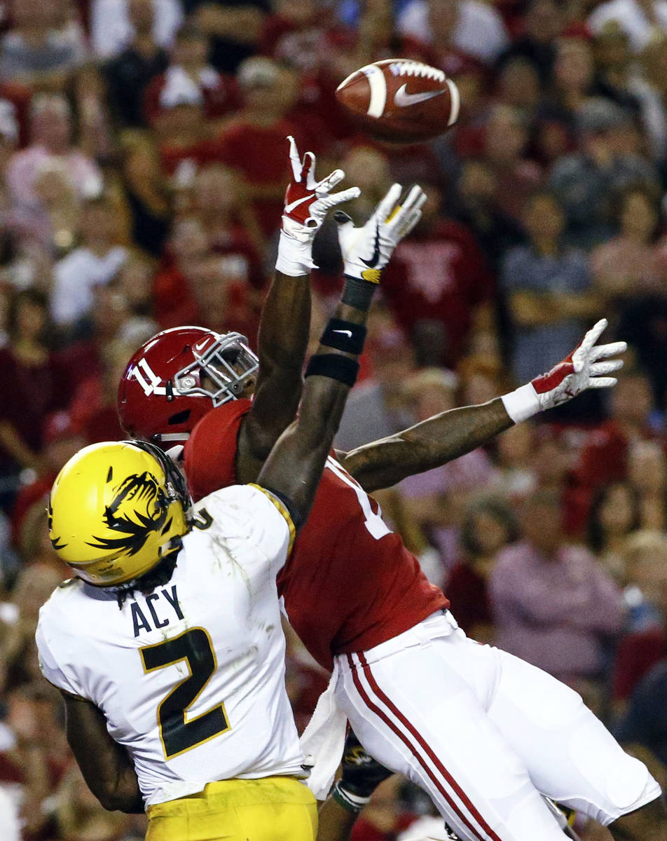 Missouri defensive back DeMarkus Acy (2) breaks up a pass intended for Alabama wide receiver He ...