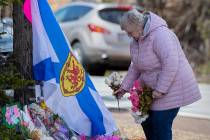 A woman pays her respects at a roadside memorial in Portapique, Nova Scotia on Thursday, April ...