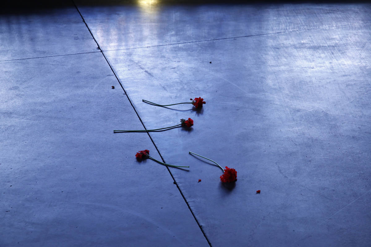 Flowers lie on a sidewalk along the Las Vegas Strip devoid of the usual crowds as casinos and o ...