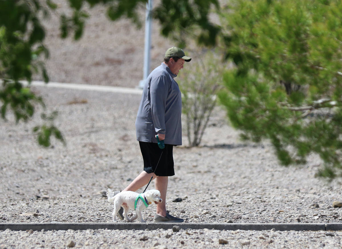 Jim Caranby of Henderson walks with his dog, Marshmello, at Cornerstone Park on Wednesday, Apri ...