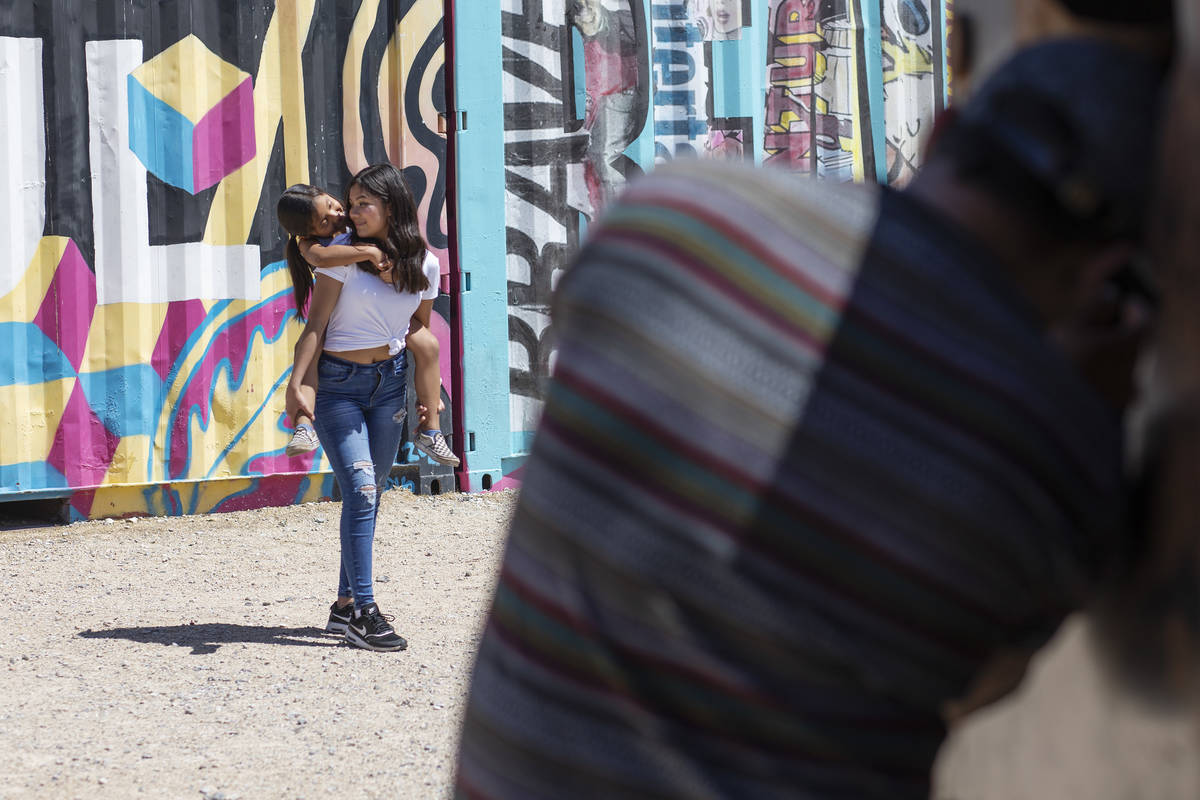Jackie Rosales, 13, holds her little sister Alice Rosales, 6, as their father Luis Rosales take ...