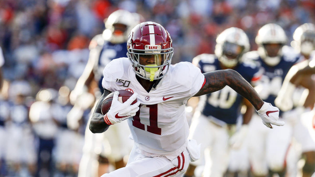 Alabama wide receiver Henry Ruggs III (11) caries the ball against Auburn during an NCAA colleg ...