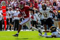 FILE - In this Sept. 21, 2019, file photo, Alabama wide receiver Henry Ruggs (11) runs in for a ...