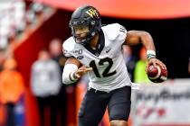 FILE - In this Nov. 30, 2019, file photo, then-Wake Forest quarterback Jamie Newman scrambles o ...