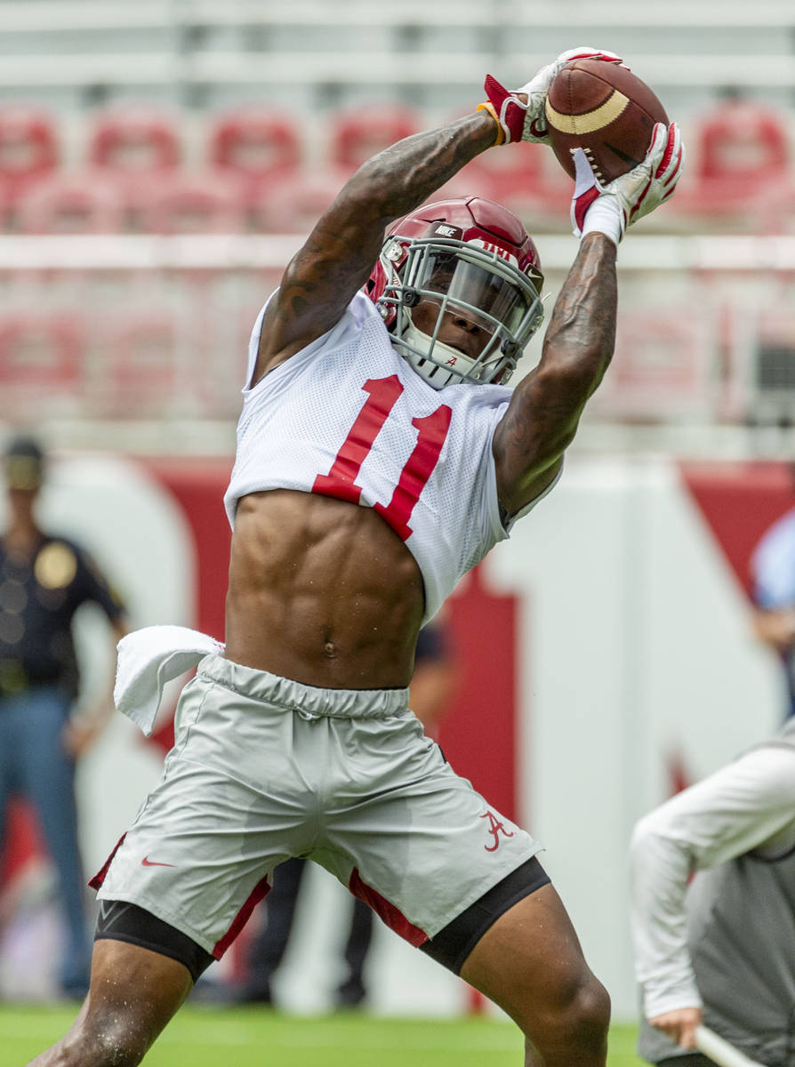 Alabama wide receiver Henry Ruggs III (11) works through drills in Alabama's fall camp fan-day ...