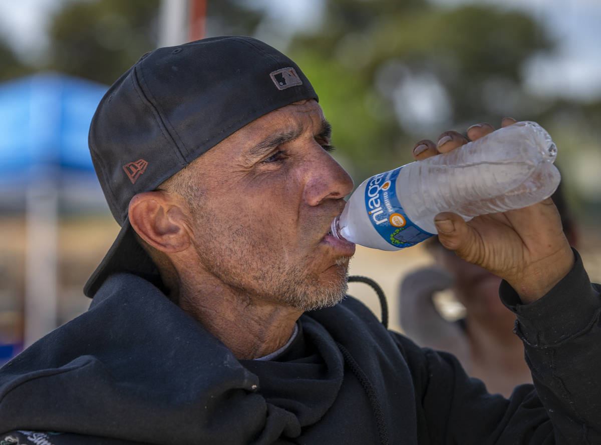Client Kevin Ball does his best to stay hydrated within the Courtyard Homeless Resource Center ...