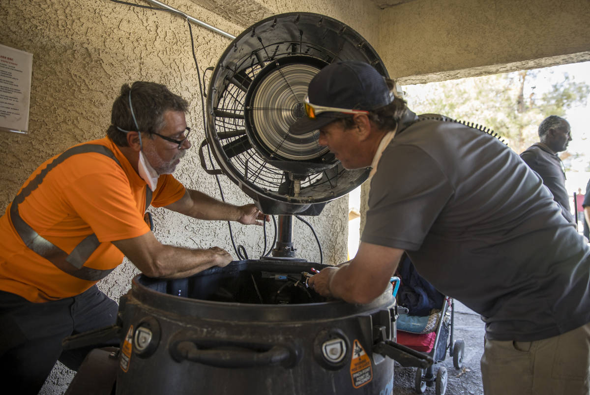 One of the new cooling fans is adjusted within the Courtyard Homeless Resource Center as temper ...