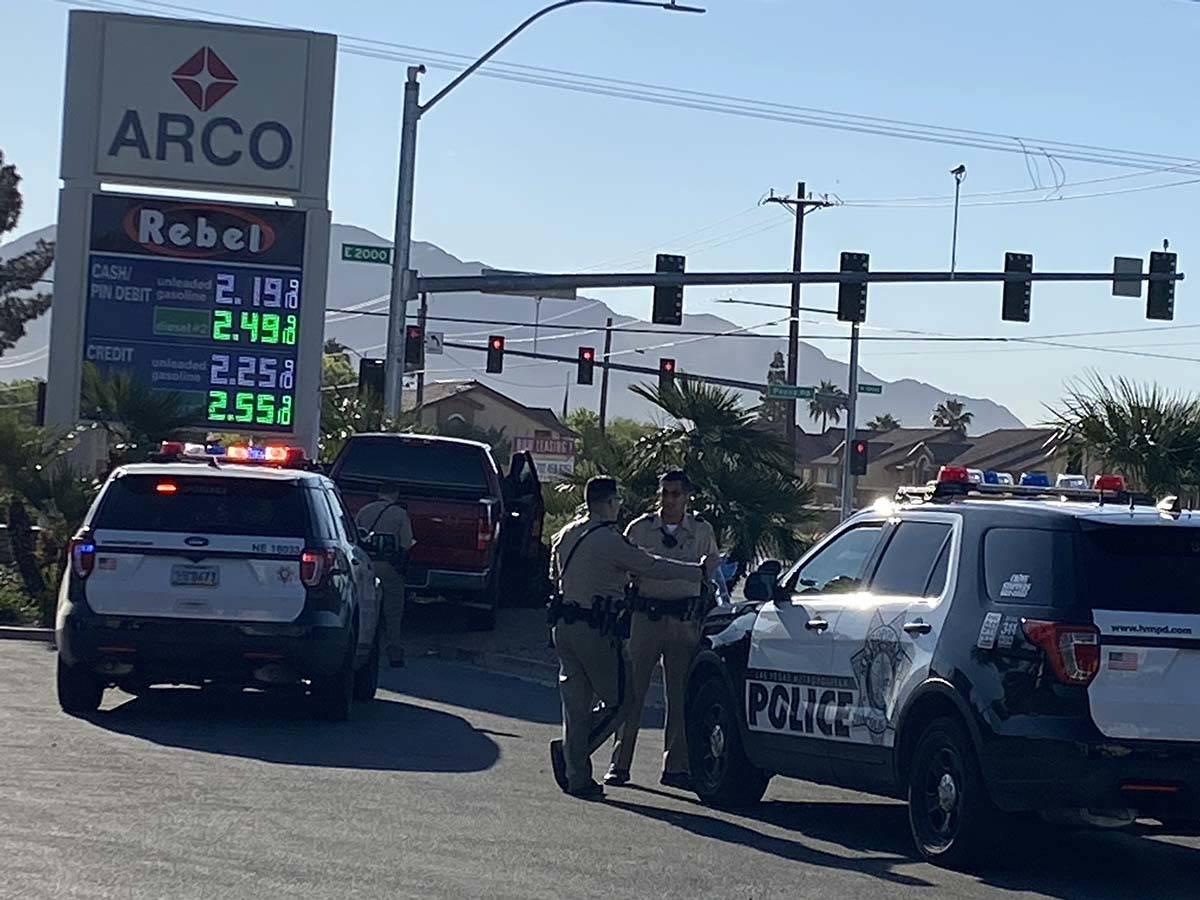 Police investigate near a convenience store at Pecos Road and Lake Mead Boulevard on Wednesday, ...