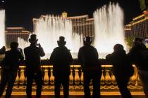 People enjoy the Bellagio fountain show on the Strip on Tuesday, Dec. 31, 2019, in Las Vegas. ( ...