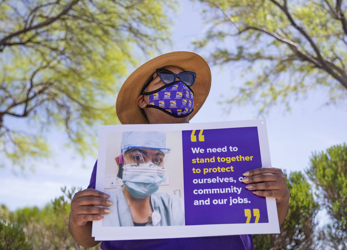 Zavia Norman, private sector vice president of Local SEIU 1107, holds a sign in protest of unsa ...