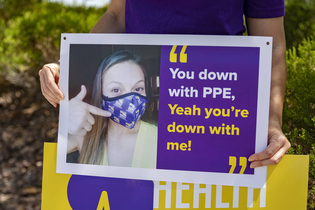 Local SEIU 1107 member holds a sign in protest of unsafe working conditions during the COVID-19 ...