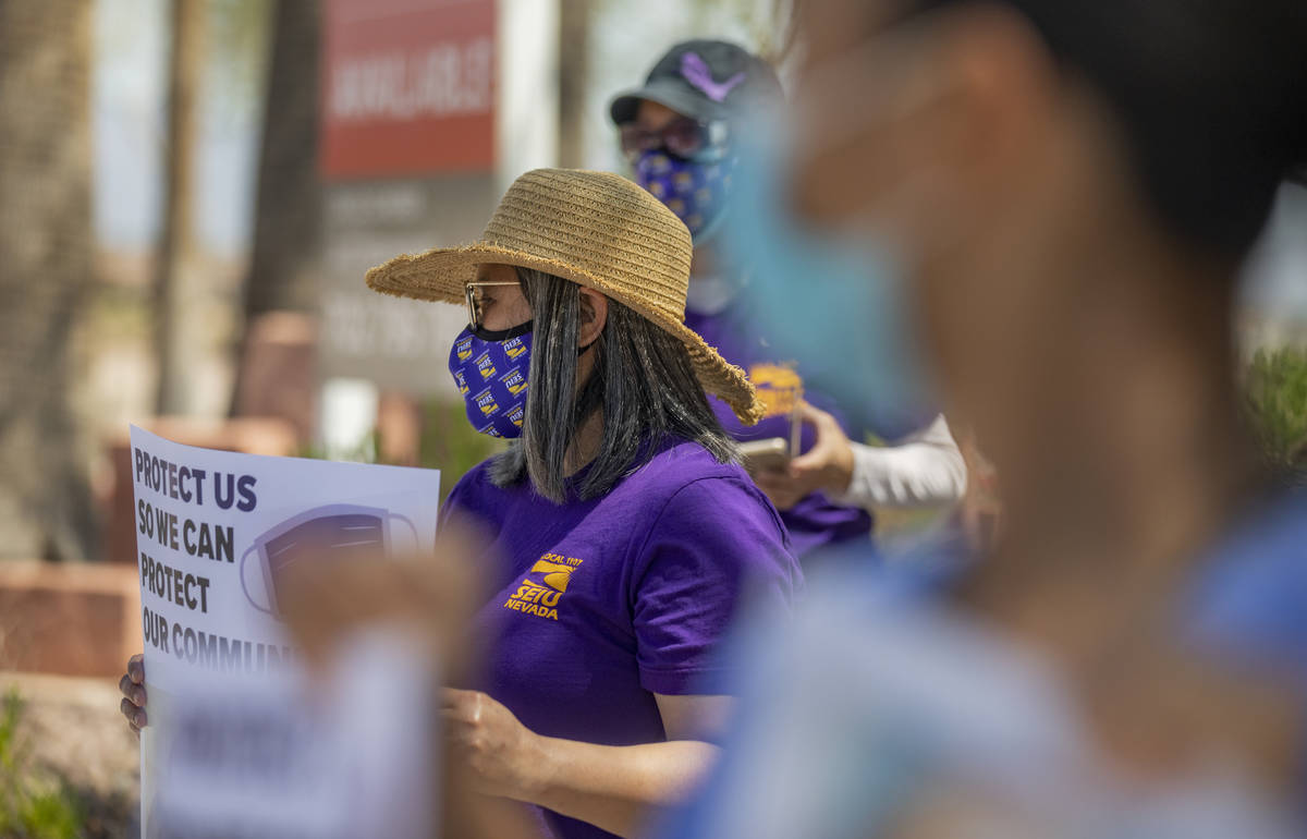 Grace Vergara-Mactal, executive director of Local SEIU 1107, holds a sign in protest of unsafe ...