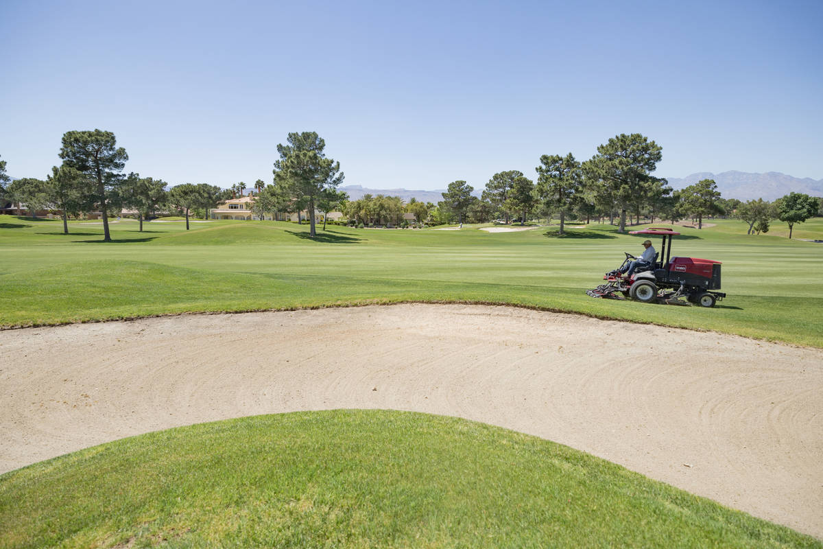 Groundskeeping is done to prepare for the opening of the Spanish Trail Country Club and Golf Co ...