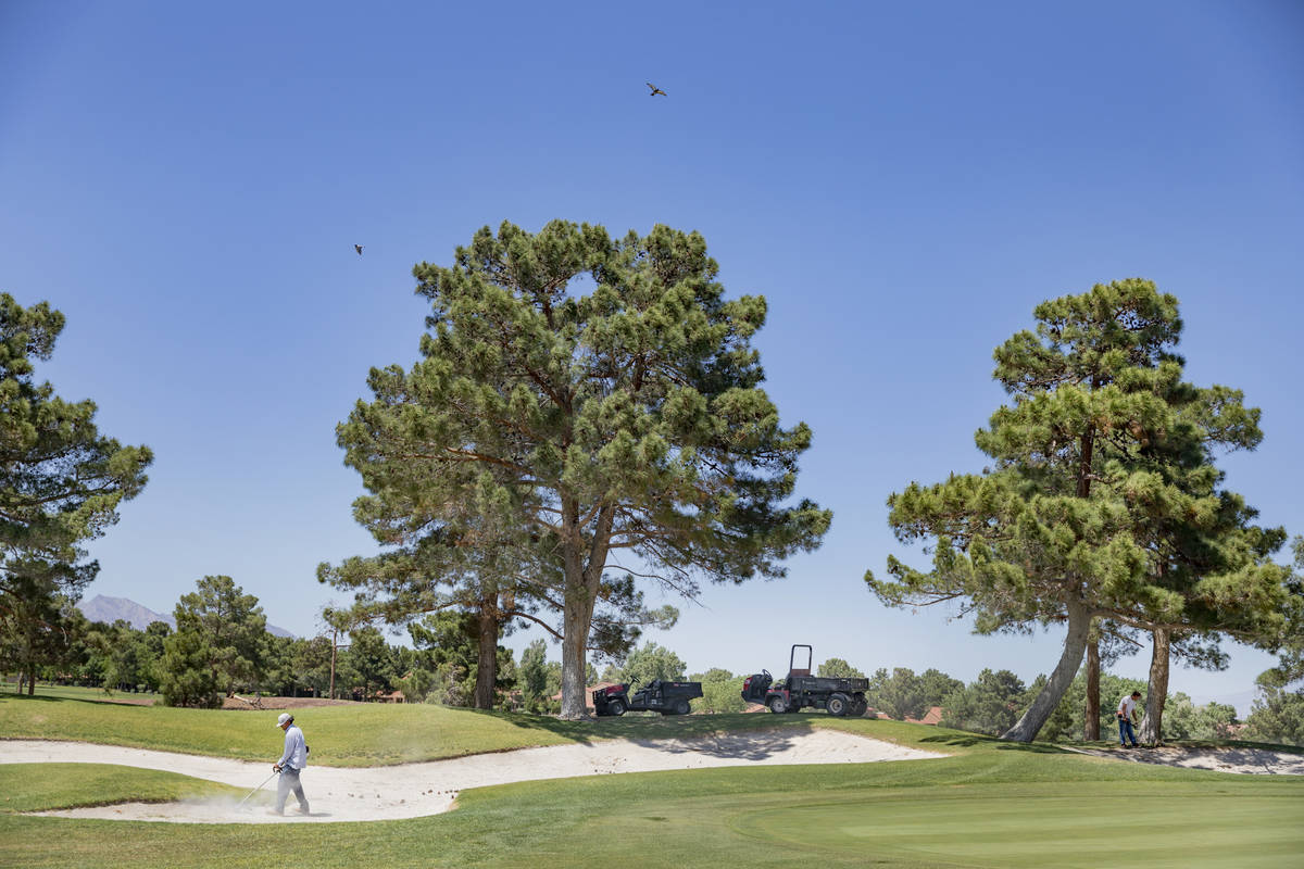 Groundskeepers prepare for the opening of the Spanish Trail Country Club and Golf Course in Las ...