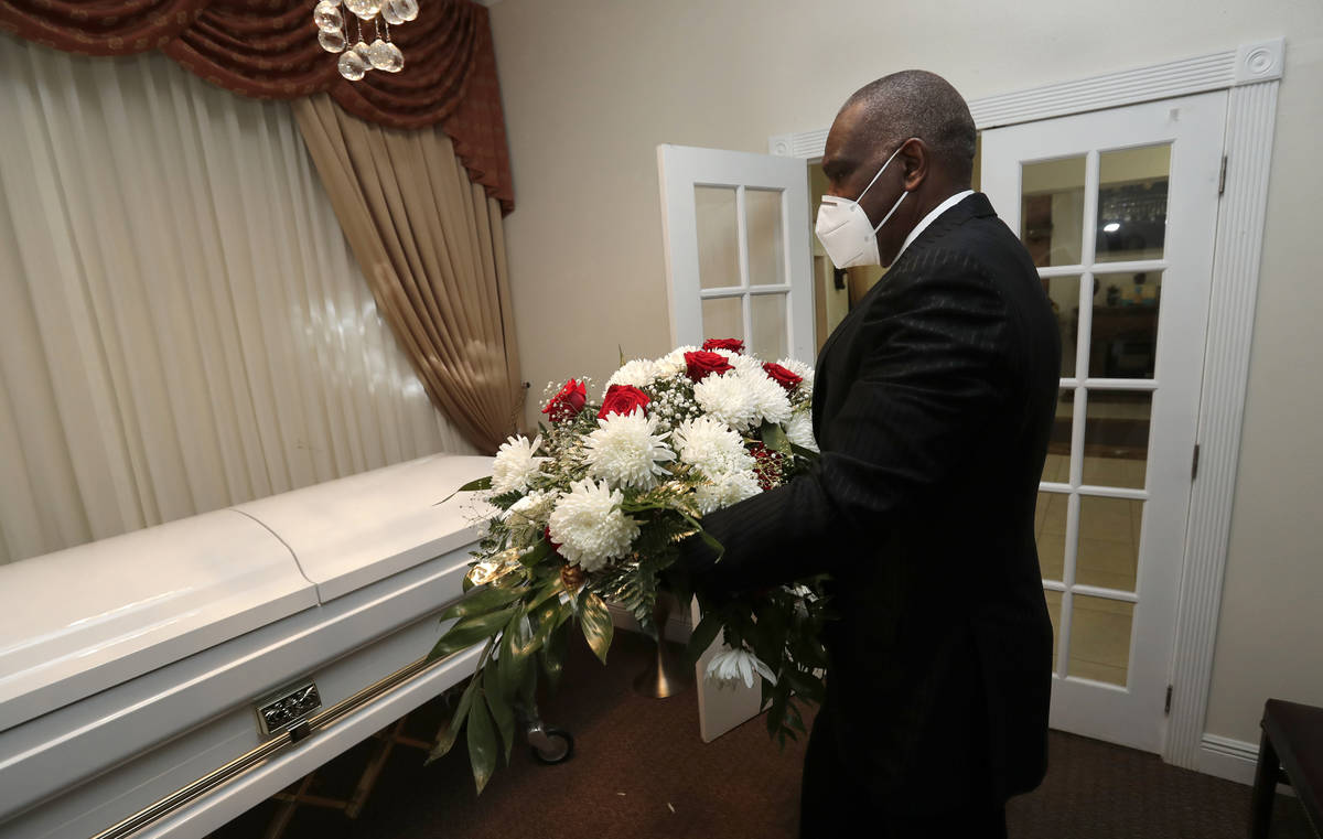 Baseball Hall of Famer Andre Dawson puts an arrangement of flowers on a casket at Paradise Memo ...