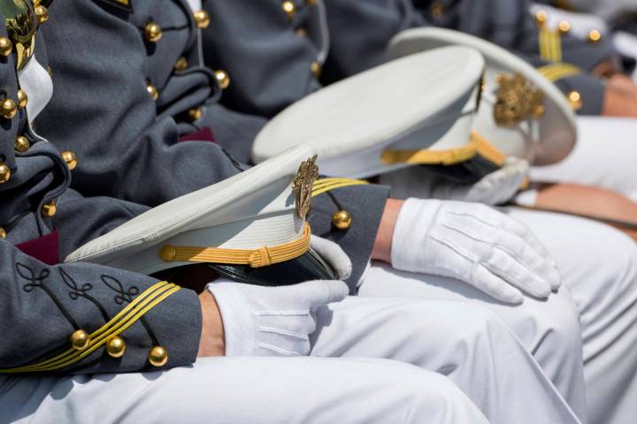 FILE - In this May 25, 2019, file photo West Point cadets hold their caps on their laps during ...