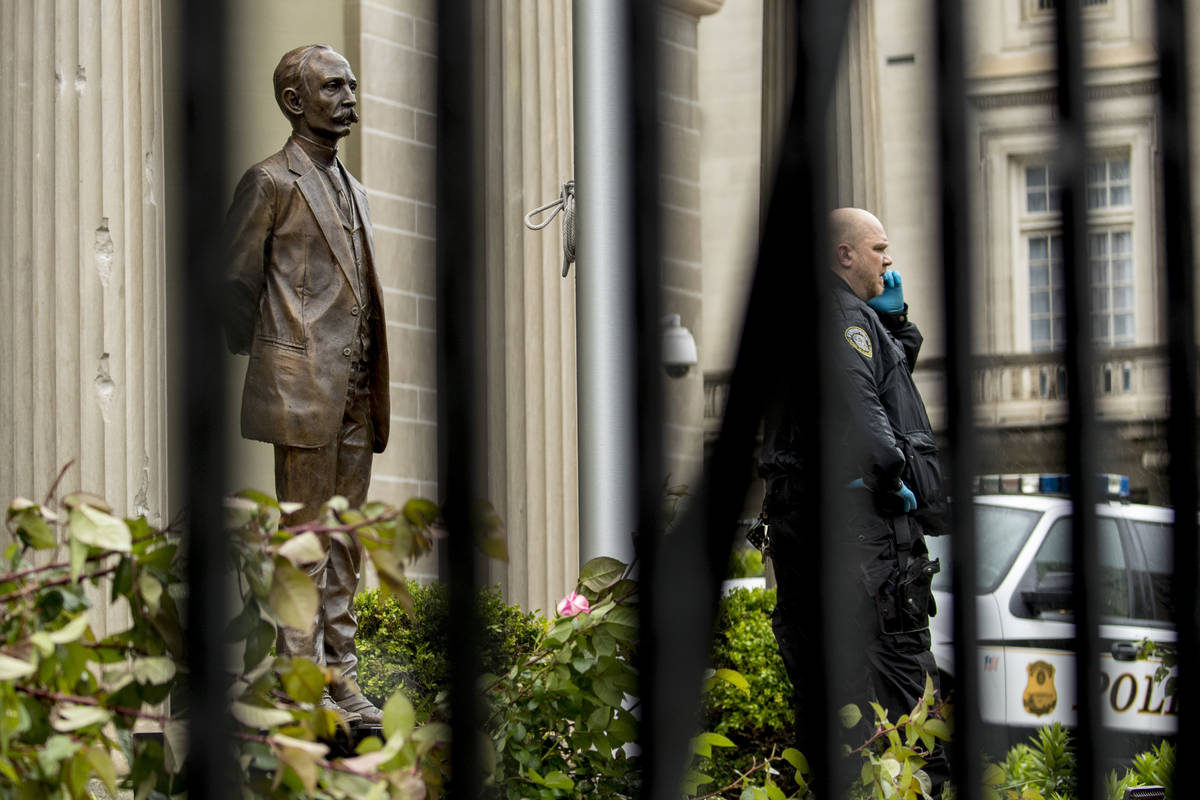 Bullet holes are visible on a column behind a statue of Cuban independence hero José Mart& ...