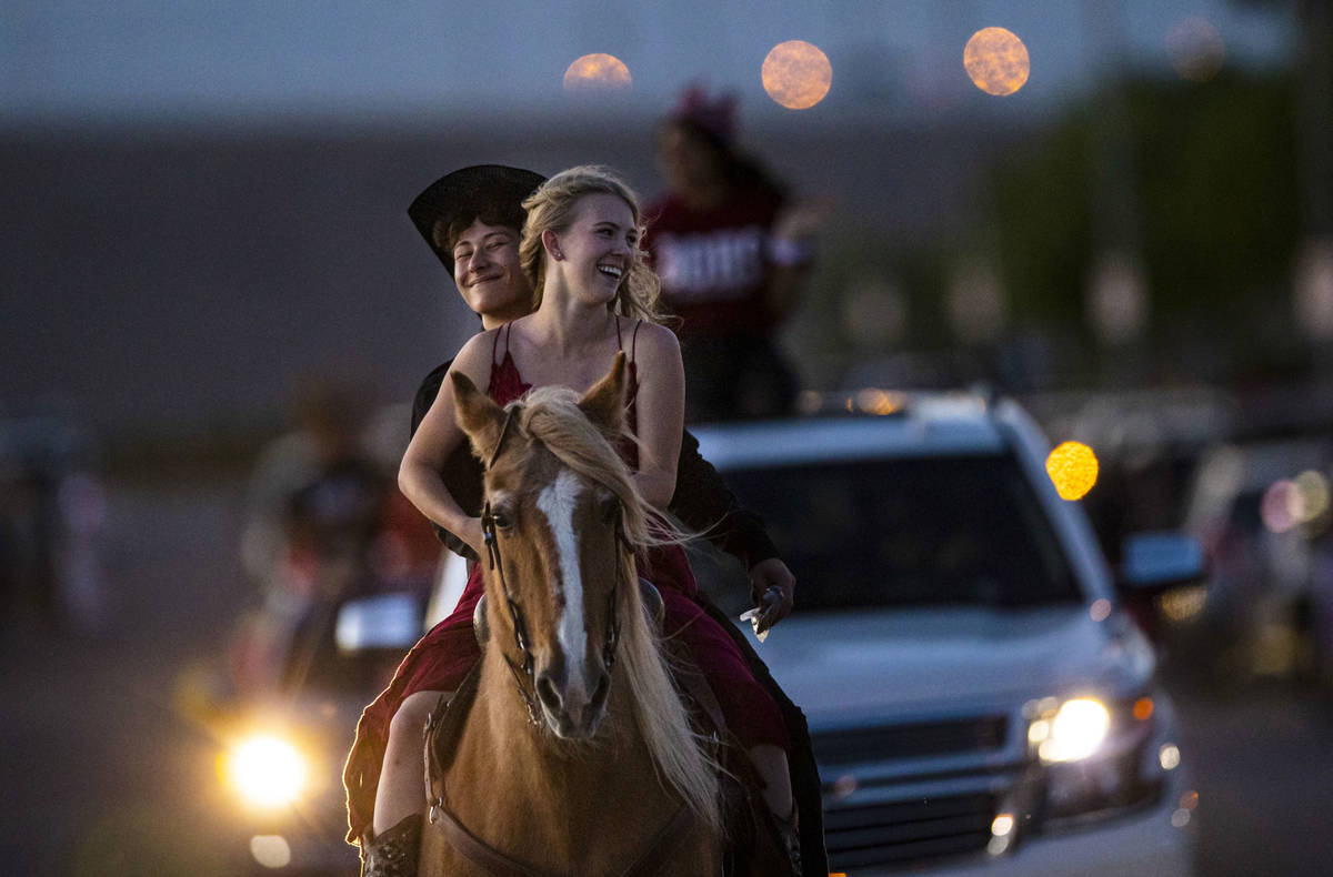 Desert Oasis High School seniors Logan Johnson, left, and Kenzie Matthews participate in a seni ...