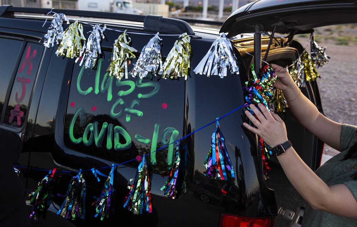 Vanessa Galvez sets up decorations before the start of the Desert Oasis High School senior prom ...