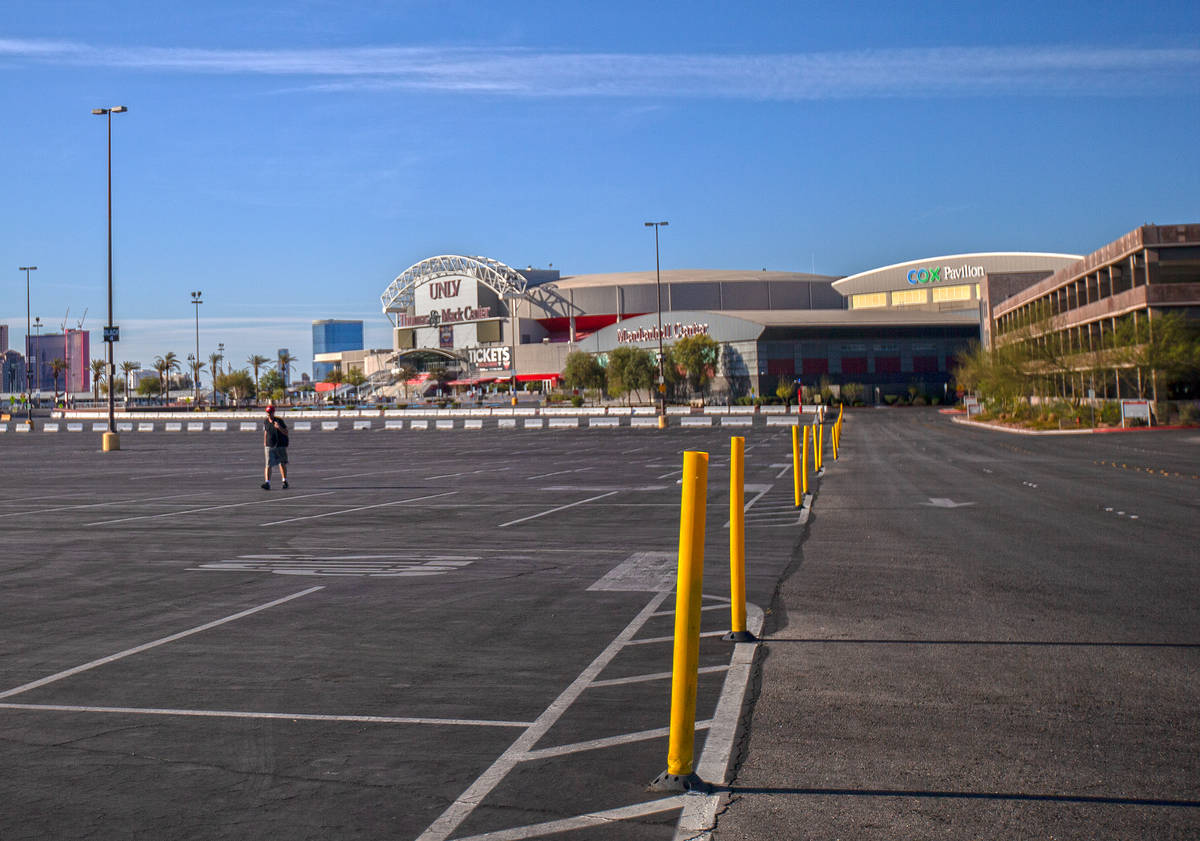 A pedestrian walks through the empty parking lot of the Thomas & Mack Center on Saturday, April ...