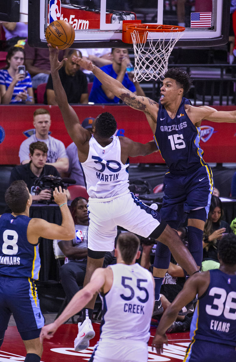Minnesota Timberwolves forward Kelan Martin, has another shot blocked by Memphis Grizzlies forw ...