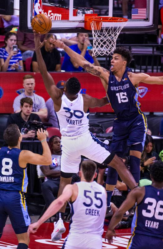 Minnesota Timberwolves forward Kelan Martin, has another shot blocked by Memphis Grizzlies forw ...