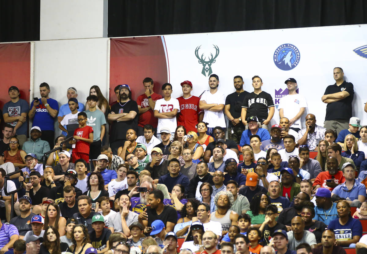 Basketball fans watch the first half a basketball game between the Boston Celtics and the Denve ...