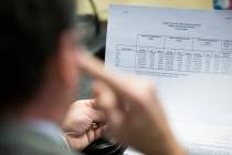 A member of the Board of Regents looks at a budget from final years 2011 and 2015 during a spec ...