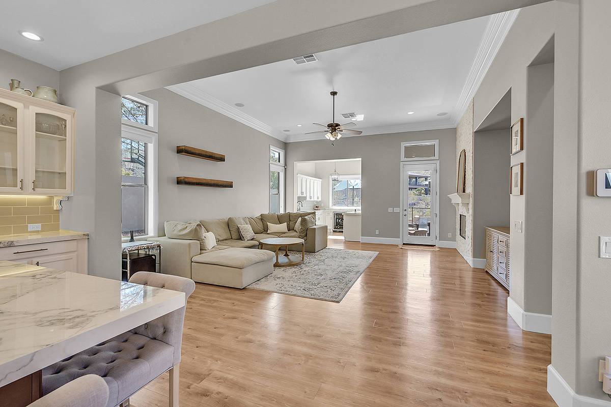 The medium-tone, luxury, vinyl-plank flooring is throughout the house. (Huntington & Ellis)
