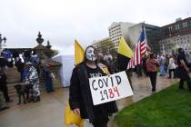 Protesters rally at the state Capitol in Lansing, Mich., Thursday, April 30, 2020. Hoisting Ame ...