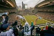 Seattle Seahawks fans cheer and wave their 12th man towels during the opening kickoff of the Se ...