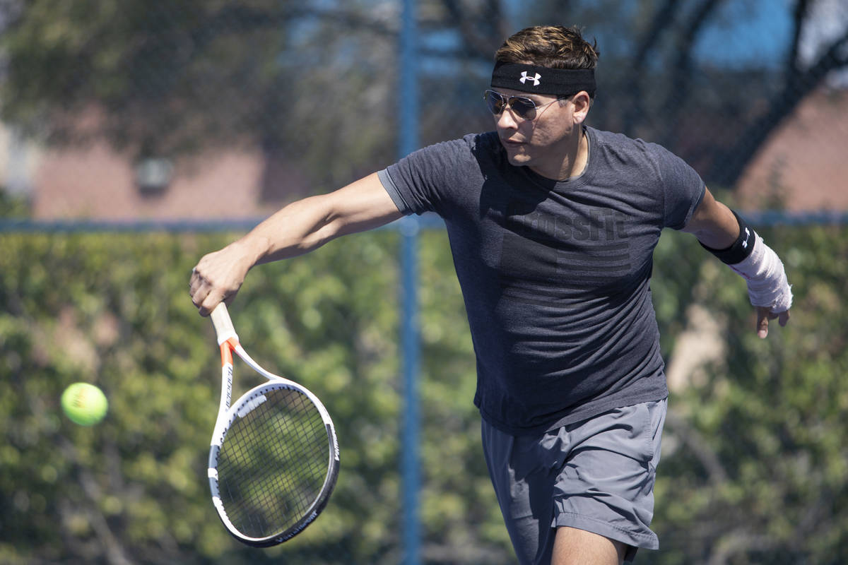 Daniel Nunez plays tennis with his girlfriend at Darling Tennis Center on Friday, May 1, 2020, ...