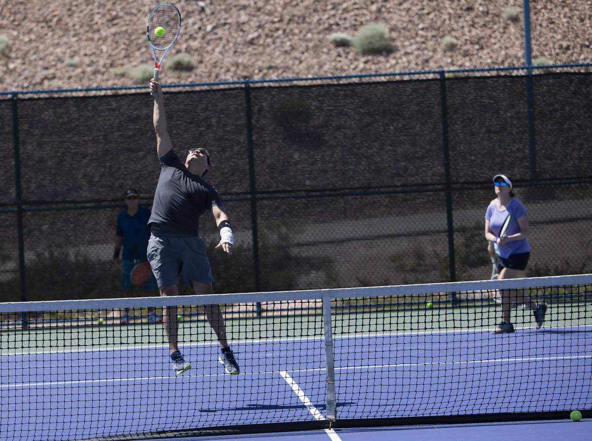 Daniel Nunez jumps for a shot during a tennis class at Darling Tennis Center on Friday, May 1, ...