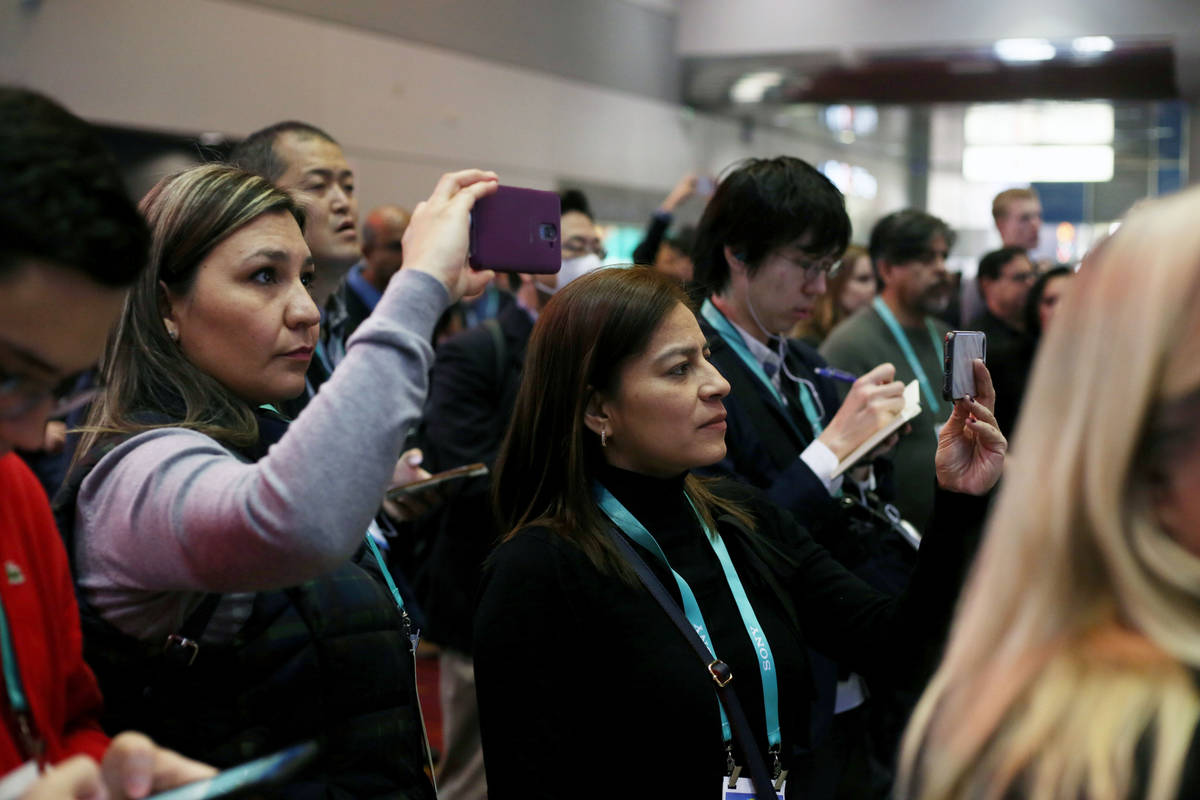 A crowd gathers to watch Las Vegas high school students presents app ideas during the Student B ...