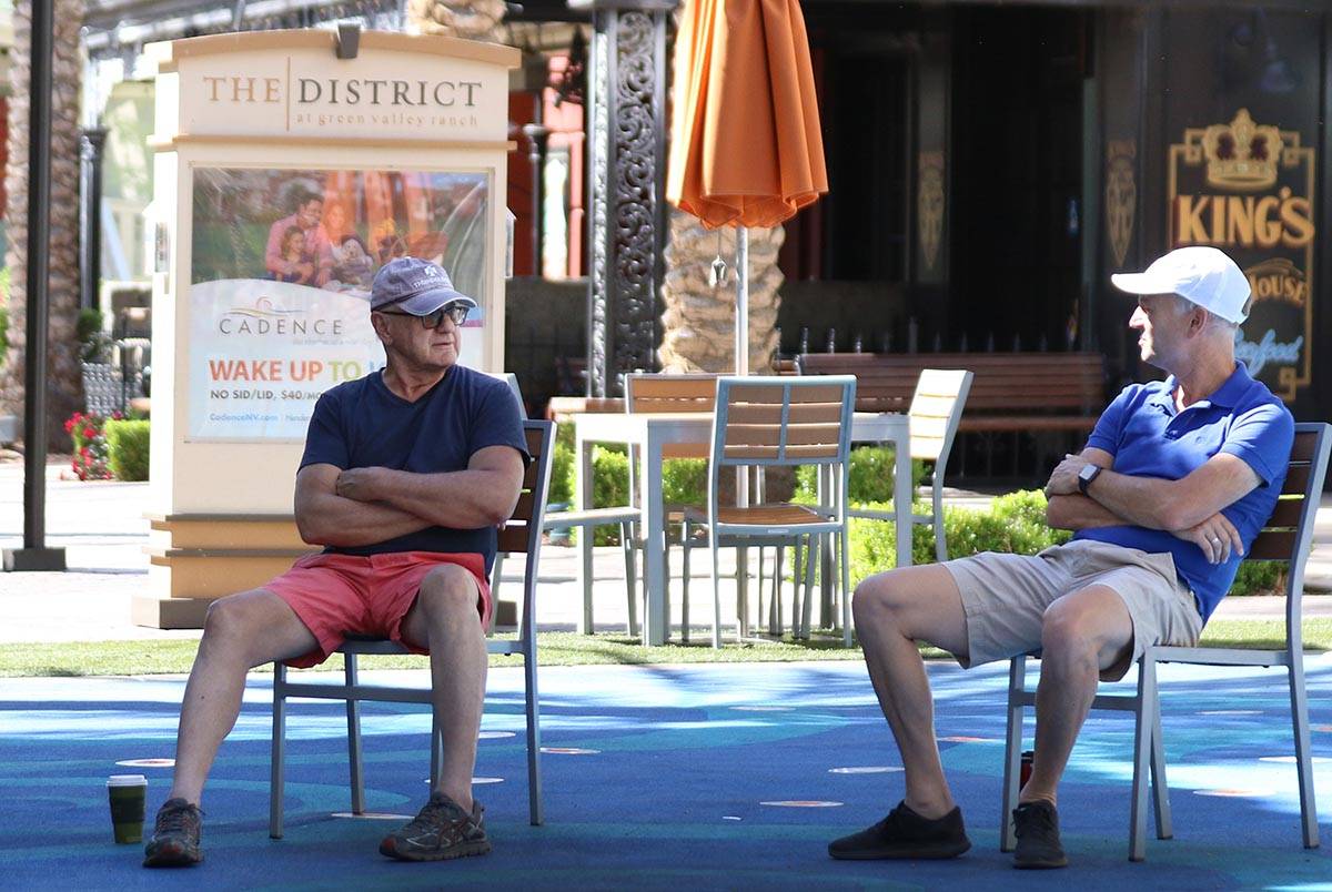 Tom Nolte, left, and Paul, who declined to give his last name, chat while social distancing at ...