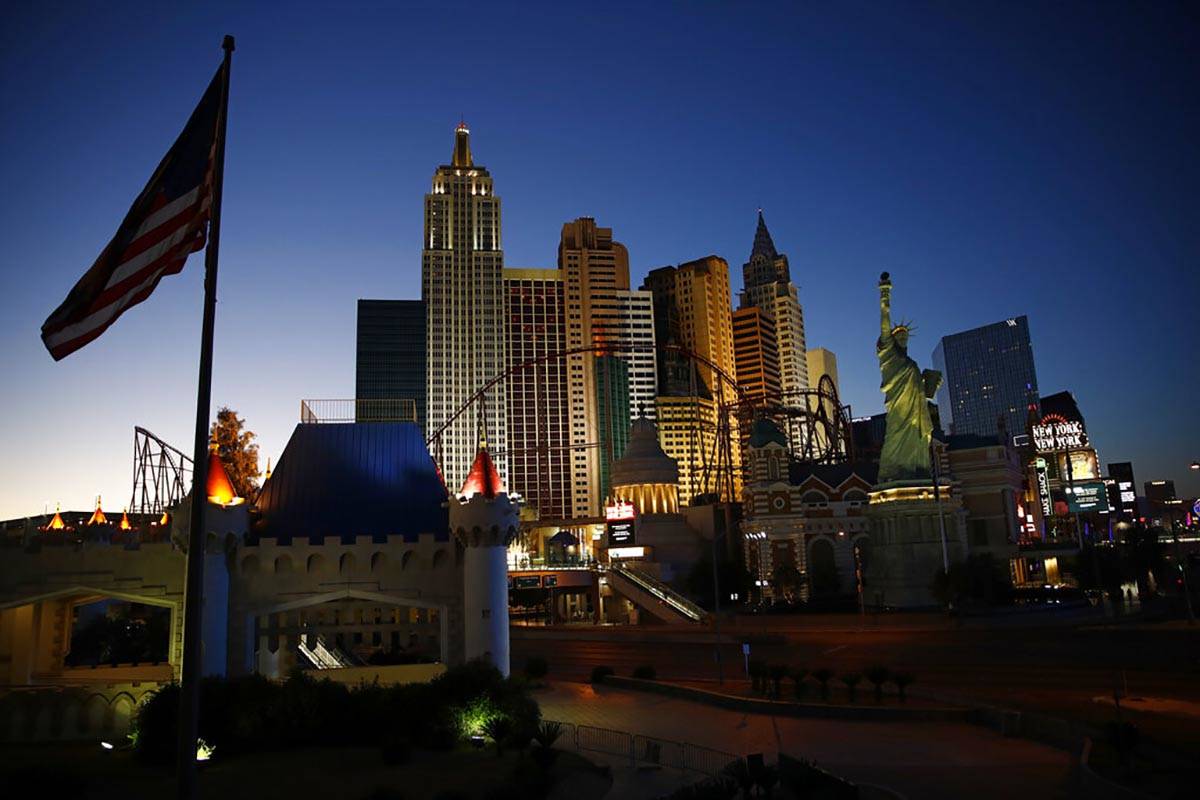 The sun sets along the Las Vegas Strip devoid of the usual crowds and traffic after casinos and ...