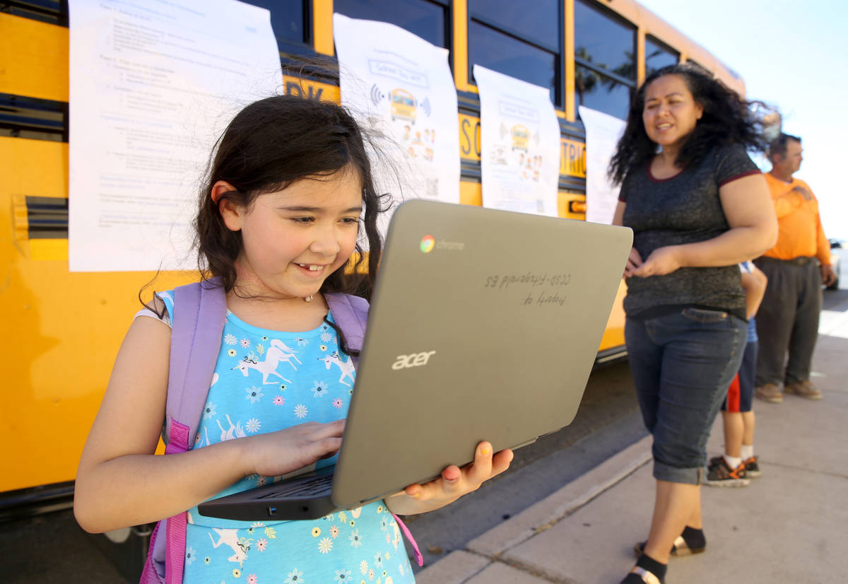 Paula Santana, 7, works on homework at the Clark County School District Wi-Fi school bus Aloha ...