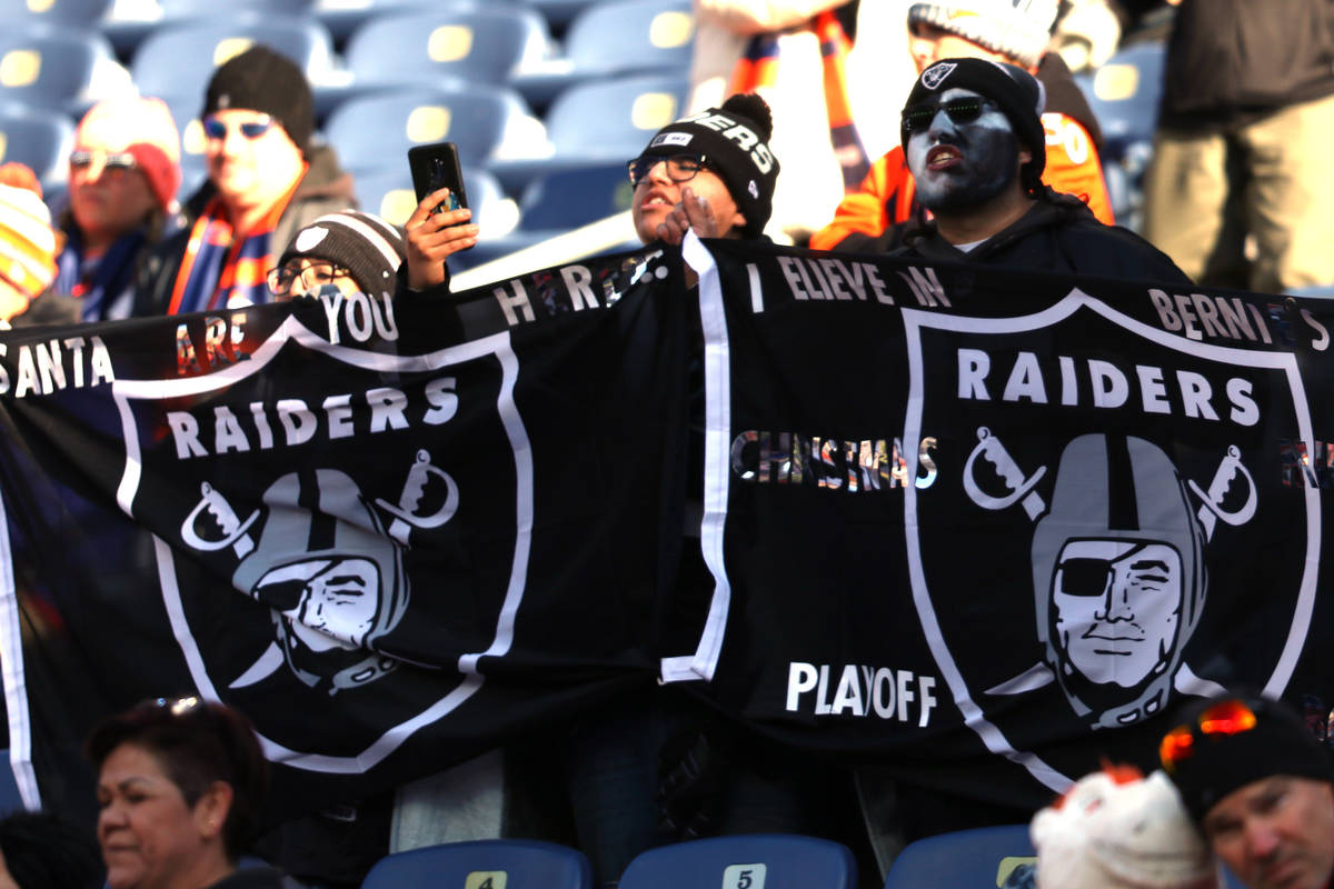 Oakland Raiders fans wave their flag prior to an NFL game against the Denver Broncos at Empower ...