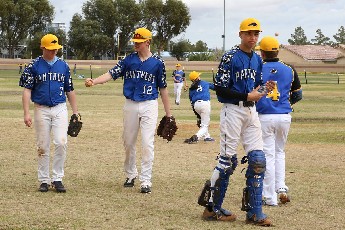 Pahranagat Valley High School players get back to the dugout after warming up during the Spring ...