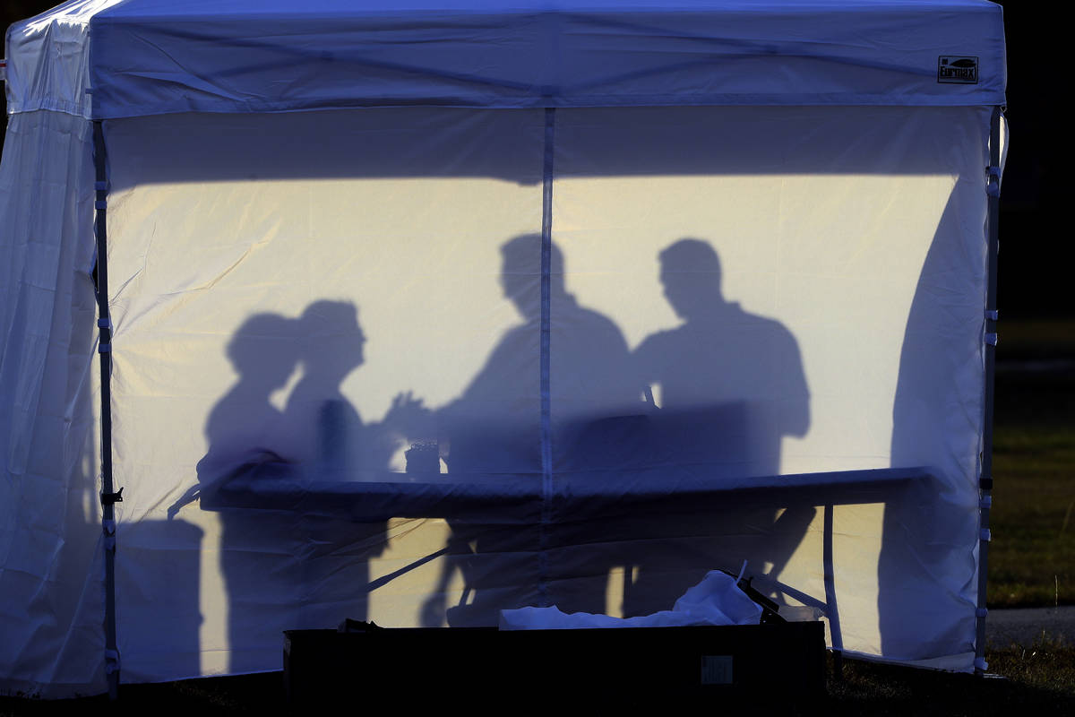 FILE - In this March 25, 2020, file photo, medical personnel are silhouetted against the back o ...