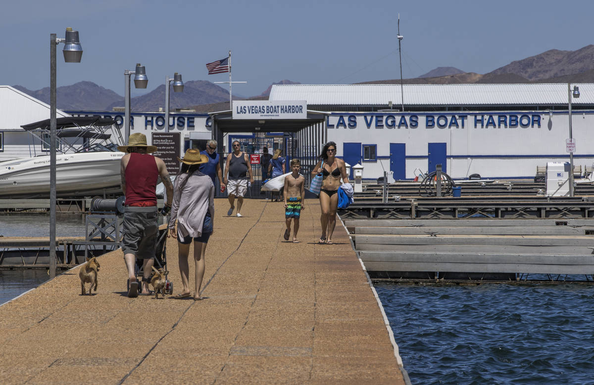 Visitors walk on the pier at the Las Vegas Boat Harbor in the Lake Mead