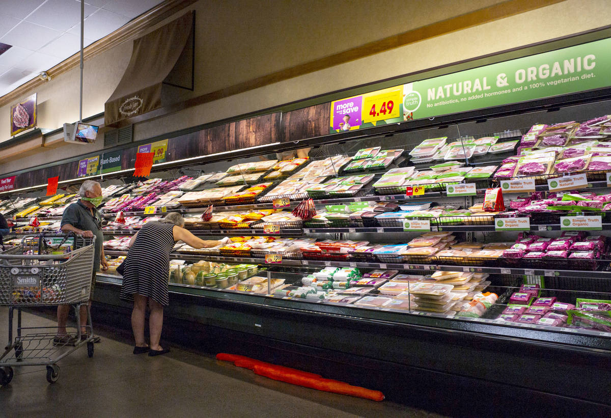 People shop for items in the meat section at Smith's in Las Vegas on Saturday, May 2, 2020. (Ch ...