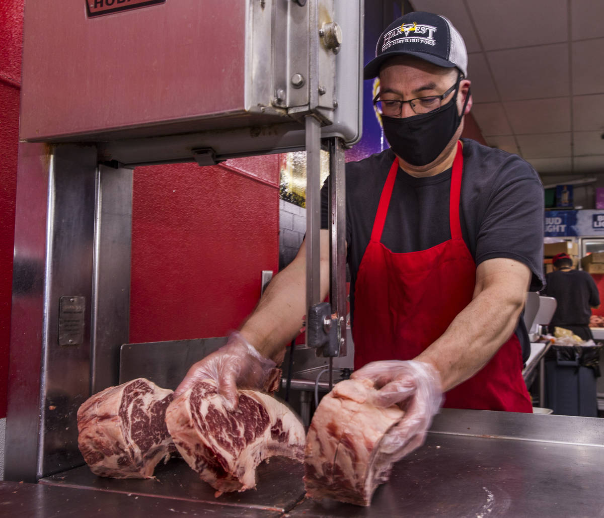 Owner Oscar Nuno Sr., cuts up beef ribeye at the Los Primos Meat Market on Sunday, May 3, 2020 ...