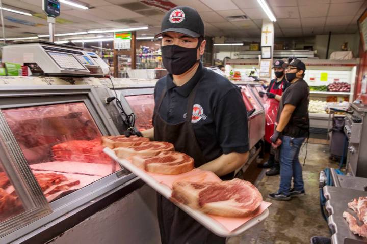 Joey Nuno stocks up a beef cooler at the Los Primos Meat Market on Sunday, May 3, 2020 in Las V ...