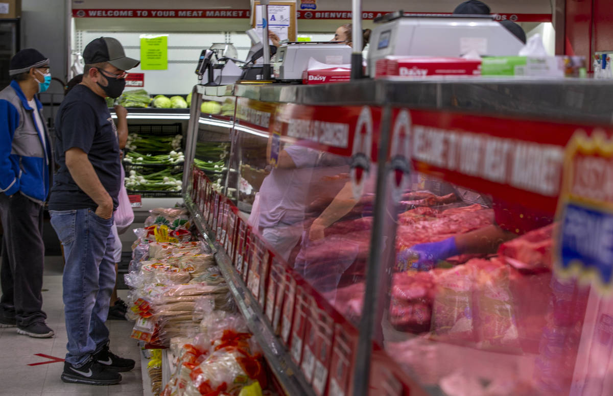 Customers look into the meat cases for their purchases at the Los Primos Meat Market on Sunday, ...