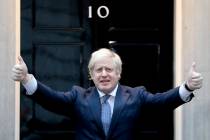 Britain's Prime Minister Boris Johnson shows thumbs up before he applauds on the doorstep of 10 ...
