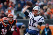 New England Patriots quarterback Tom Brady (12) passes in the first half of an NFL football gam ...